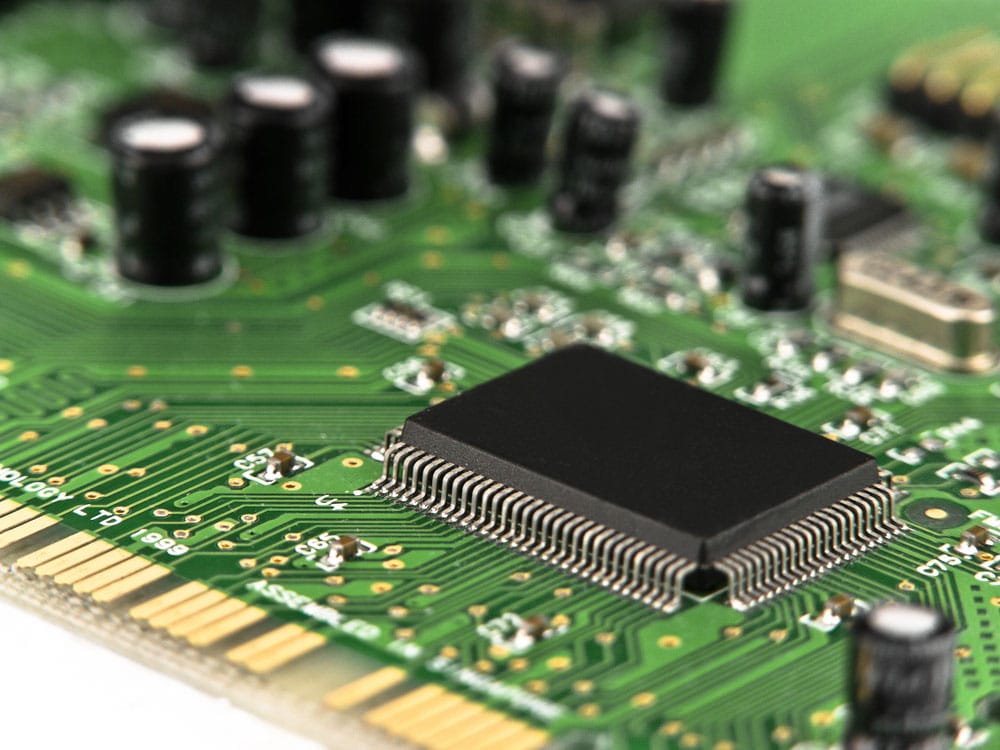 Several Capacitors and Microchips on a PCB