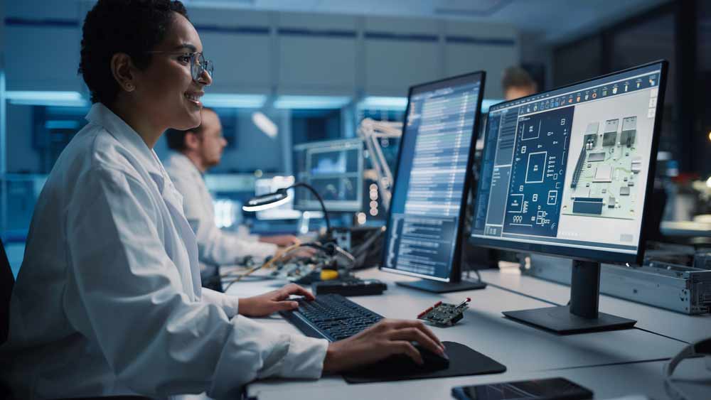 Engineers in an electronics production plant designing PCBs