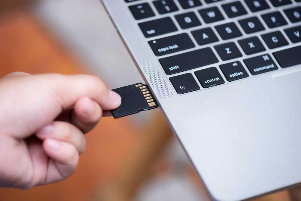 Create Image From SD Card: An SD card being inserted into a computer